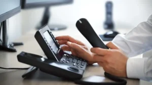 Virtual receptionist answering small business calls from a remote desk